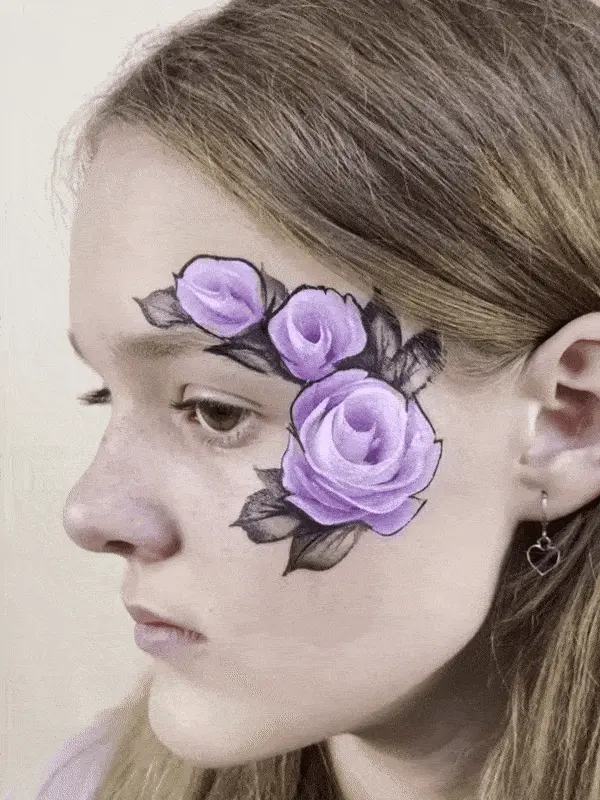 young girl with three purple roses face painted on her lef eye