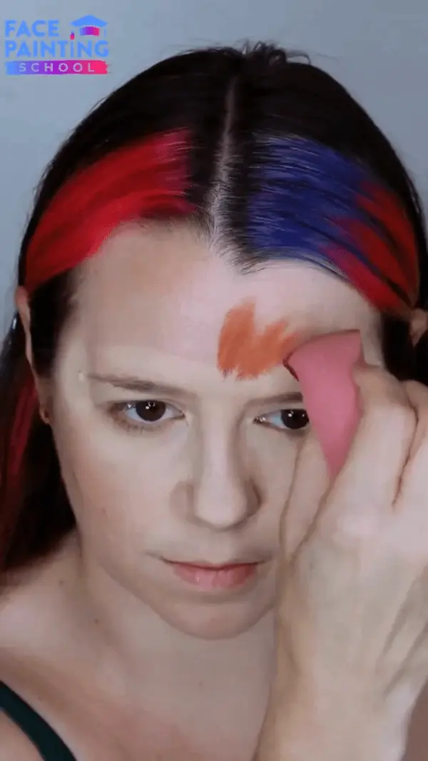 lady putting face paint on herself