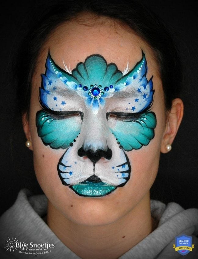 girl with a completed blue kitty cat face paint