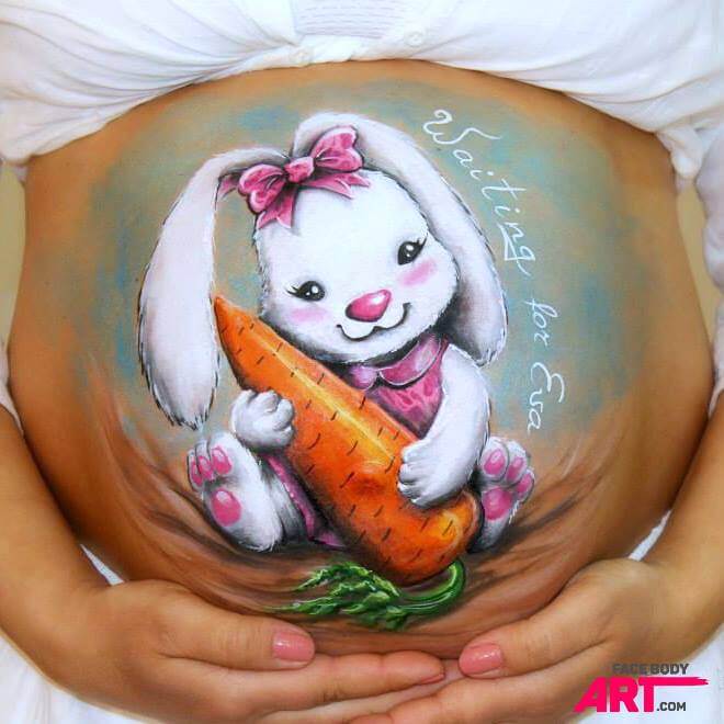 a high resolution belly paint of a female bunny witha a pink dress and bow holding a giant carrot
