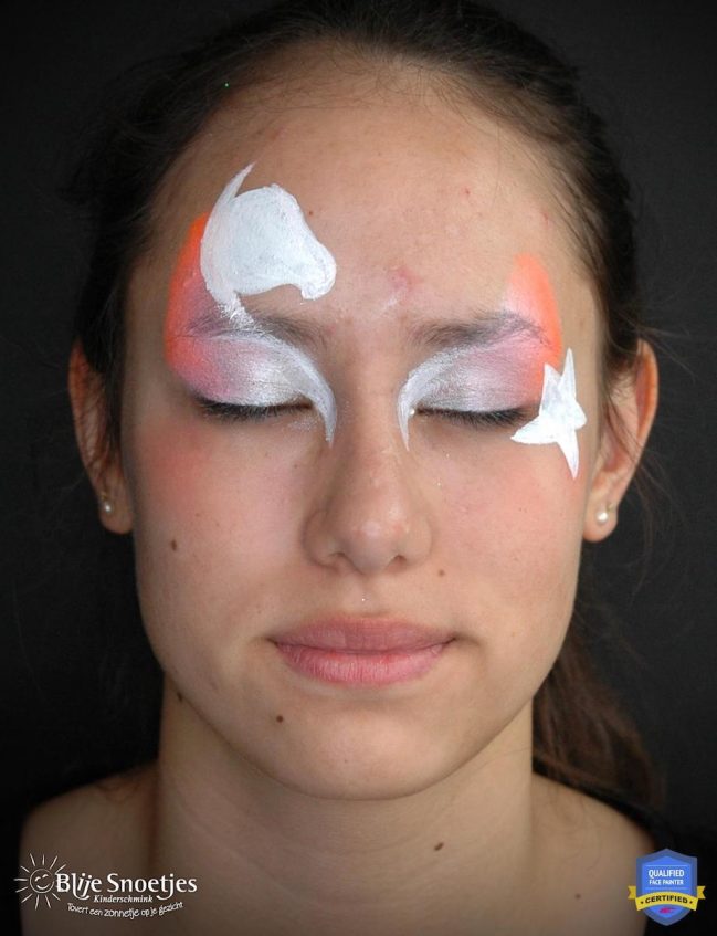 a girl with gradient white eyeshadow witha a base of a unicorn above her right eye and star next to the right eye