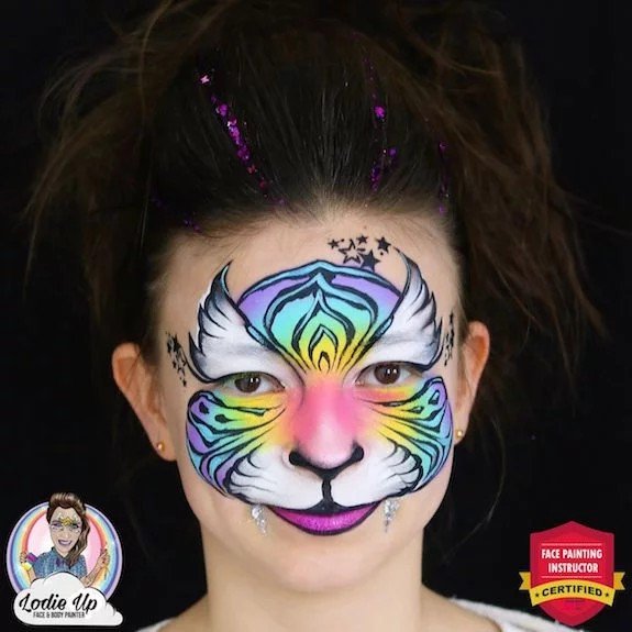 a girl with a completed colorful tiger face paint designs