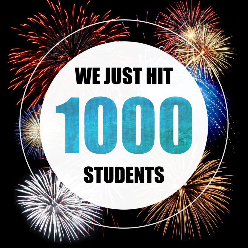 a banner with fireworks that says "We just hit 1000 students"