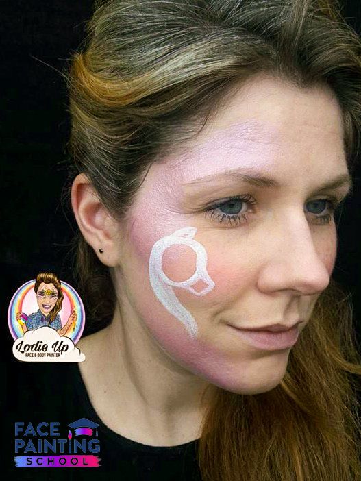 a woman with an basic outline of a unicorn face paint design on her